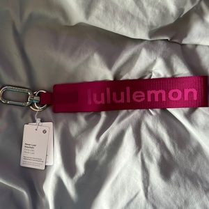 Brand new lululemon never lost keychain cranberry/pink with tags